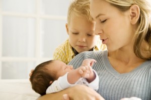 A mother and her son with a new baby